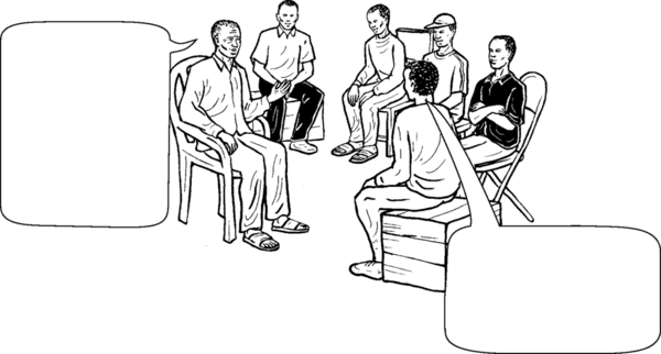 a man speaking in a group; another man responds.