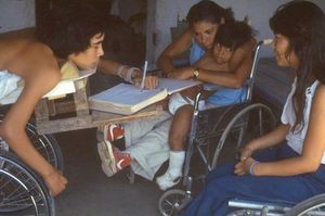 Julio writing while group watches