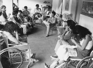 Personas discapacitadas sentados en un círculo teniendo una reunión