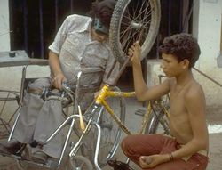 a disabled man fixing a bicycle