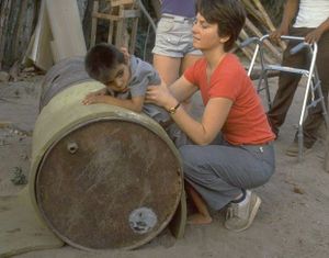 Ejercitando un niño pequeño en un barril acostado.