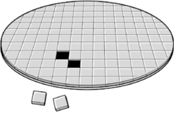 a round silicon wafer covered with rows of square chips.