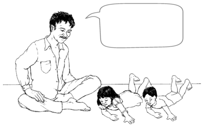 a man speaking to 2 children lying on the floor.